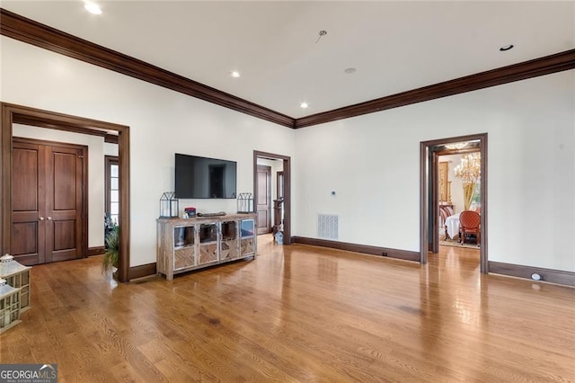 living room with light wood-type flooring and ornamental molding