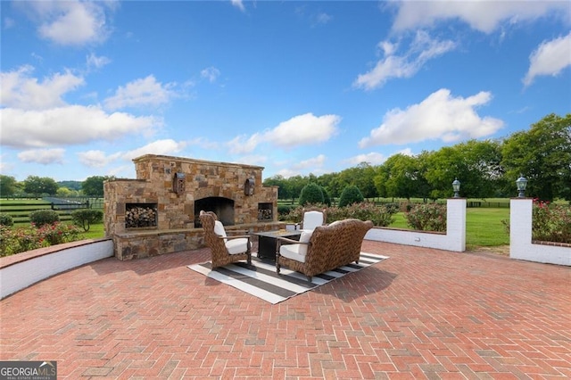 view of patio / terrace featuring an outdoor stone fireplace