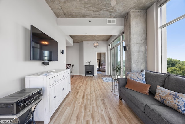 living room with an inviting chandelier and light hardwood / wood-style floors