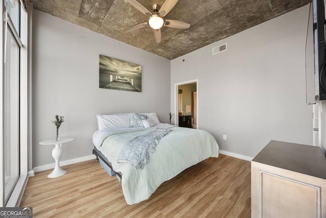 bedroom with ceiling fan and light hardwood / wood-style floors