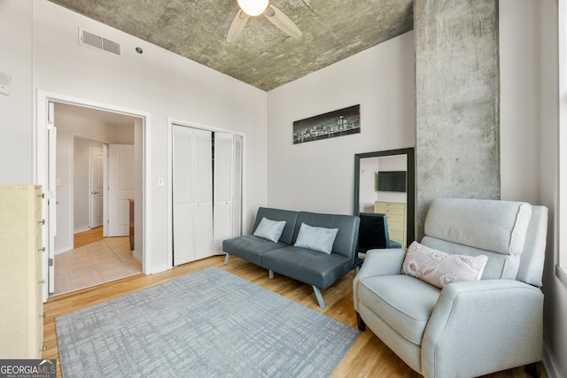 sitting room featuring ceiling fan and light wood-type flooring