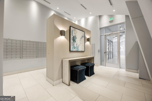 entryway featuring light tile patterned floors and a mail area