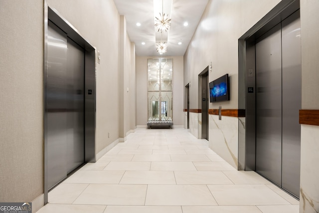 hall with elevator and light tile patterned floors