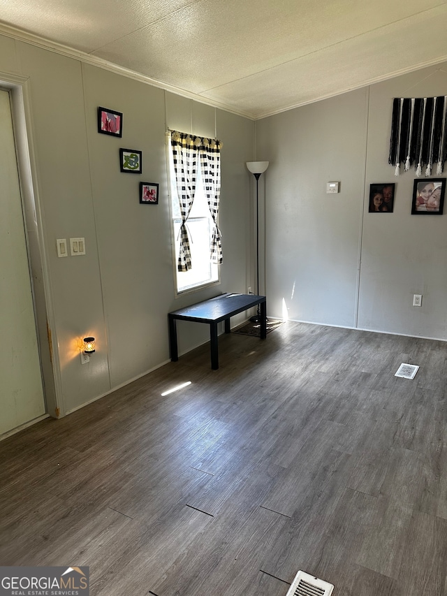 interior space with wood-type flooring and a textured ceiling