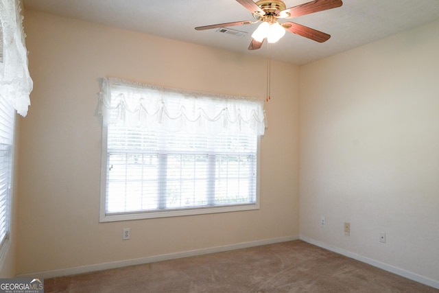 unfurnished room featuring carpet floors and ceiling fan