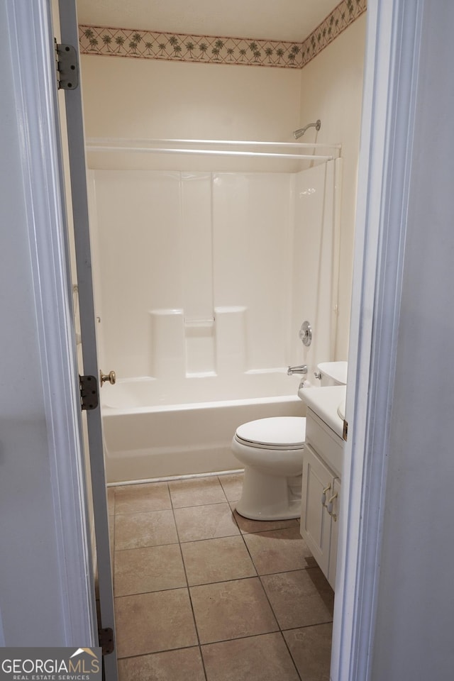 full bathroom with vanity, tile patterned flooring, washtub / shower combination, and toilet