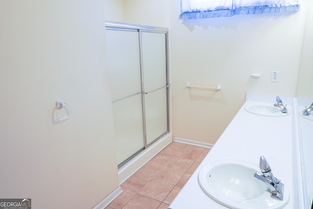 bathroom with tile patterned flooring, walk in shower, and vanity