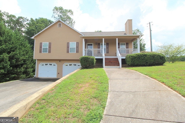 view of front of property with a porch, a garage, and a front yard