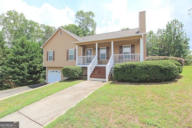 view of front of property with a garage, a porch, and a front yard