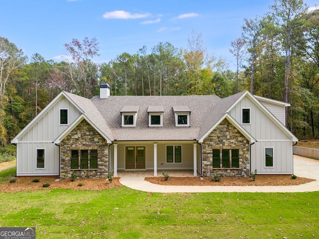 831 Banks Cir, Carrollton, GA 30116 - view of front of home featuring stone siding, a shingled roof, board and batten siding, and a front lawn