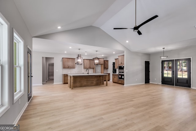 831 Banks Cir, Carrollton, GA 30116 - unfurnished living room featuring recessed lighting, healthy amount of natural light, high vaulted ceiling, a chandelier, and light wood-type flooring