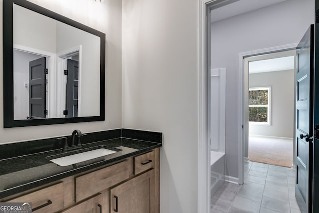 bathroom featuring vanity, a bathtub, and tile patterned flooring