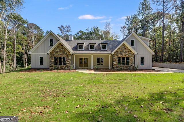 831 Banks Cir, Carrollton, GA 30116 - view of front facade featuring stone siding, a chimney, a front lawn, and board and batten siding