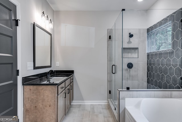 bathroom with vanity and independent shower and bath