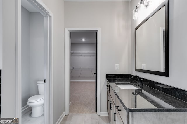 bathroom with vanity, toilet, and tile patterned floors