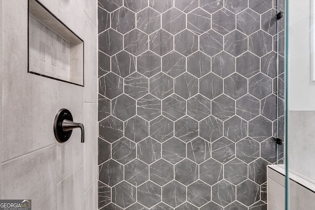 bathroom with tiled shower