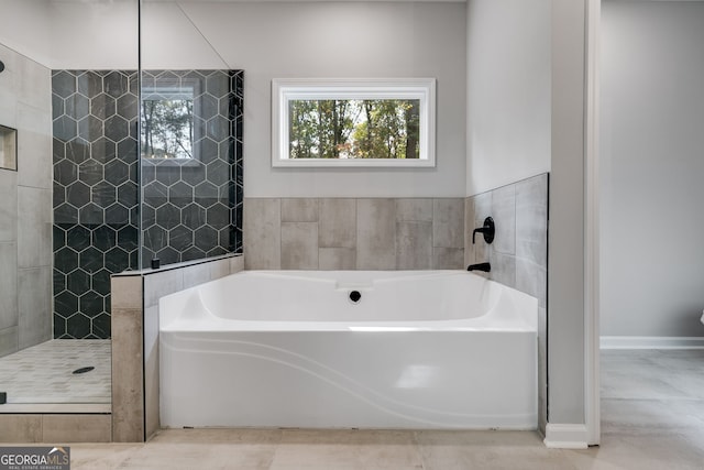 bathroom featuring shower with separate bathtub