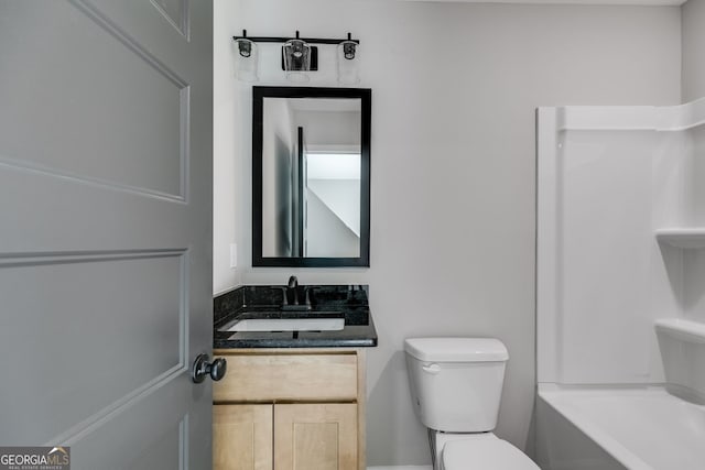 bathroom with toilet, vanity, and a washtub