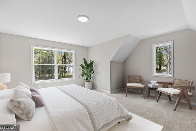 bedroom featuring lofted ceiling and light colored carpet