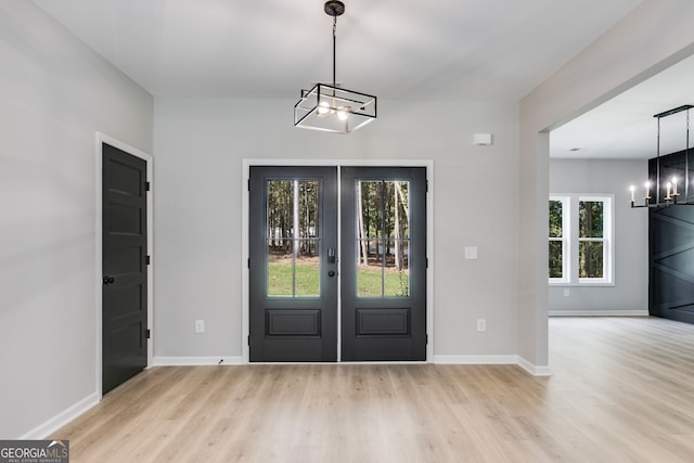 entryway featuring light hardwood / wood-style flooring, french doors, and a wealth of natural light