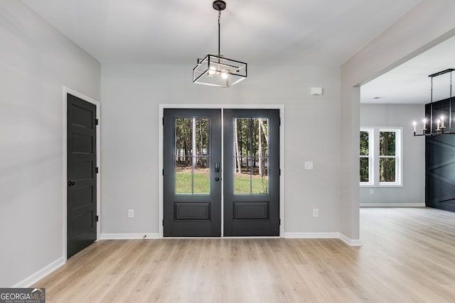 831 Banks Cir, Carrollton, GA 30116 - entryway with a chandelier, french doors, light wood-style floors, and baseboards