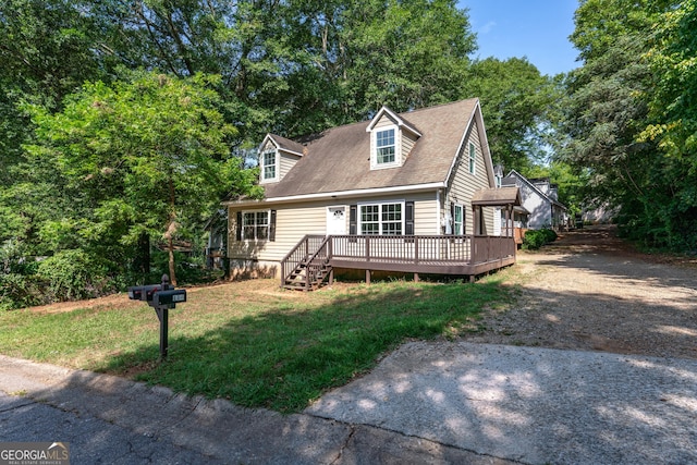 new england style home with a wooden deck and a front lawn