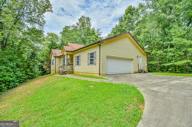 view of side of home featuring a garage and a yard