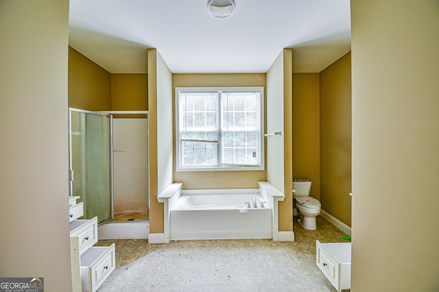 bathroom featuring toilet, tile patterned flooring, and shower with separate bathtub