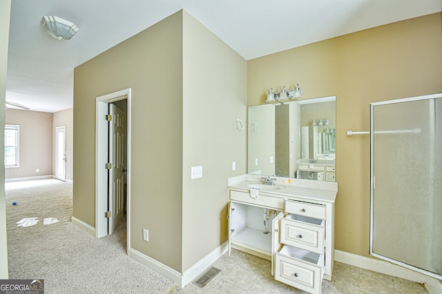 bathroom with vanity, tile patterned floors, and walk in shower