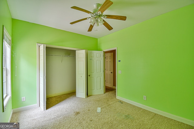 unfurnished bedroom featuring a closet, light colored carpet, multiple windows, and ceiling fan