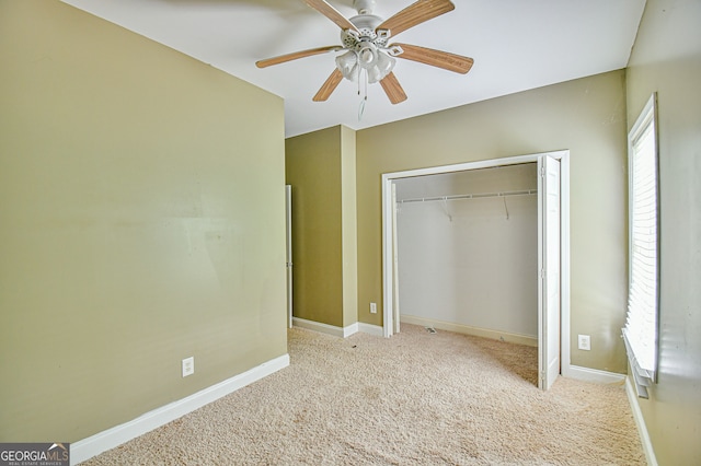 unfurnished bedroom with light carpet, ceiling fan, and a closet