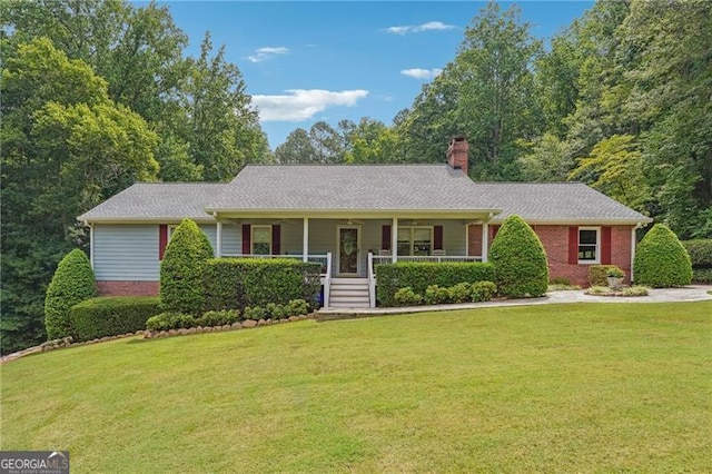 ranch-style house featuring covered porch and a front yard