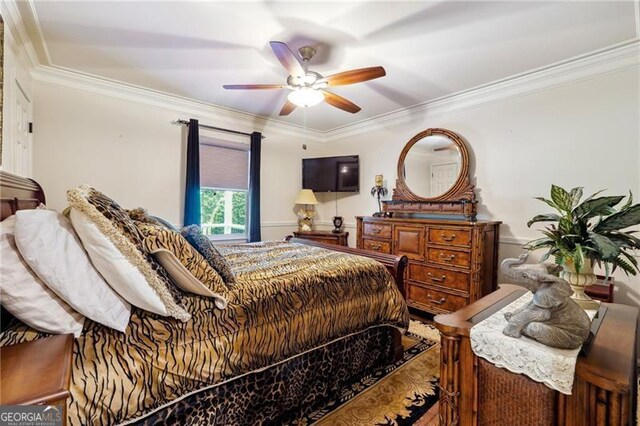 bedroom featuring ceiling fan and crown molding