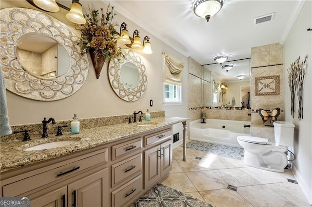 bathroom featuring toilet, vanity, tile patterned floors, a tub to relax in, and crown molding