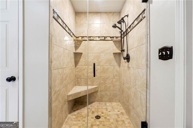 bathroom with a shower with shower door