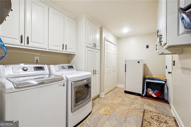 washroom with cabinets and washing machine and clothes dryer