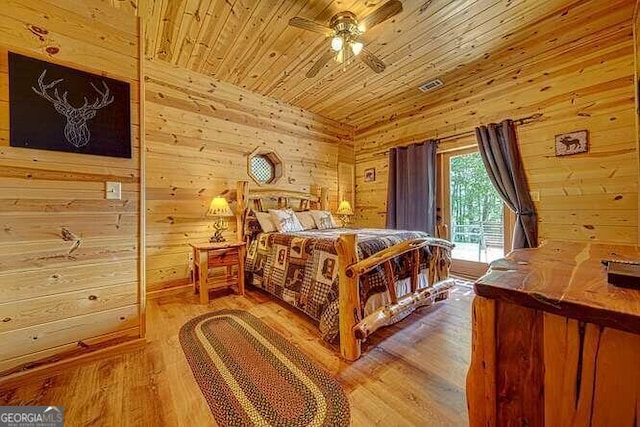 bedroom with wood ceiling, access to outside, wooden walls, and light hardwood / wood-style floors