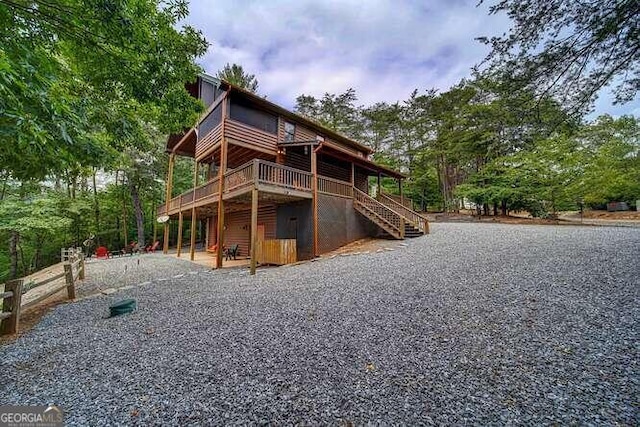 rear view of property featuring a deck