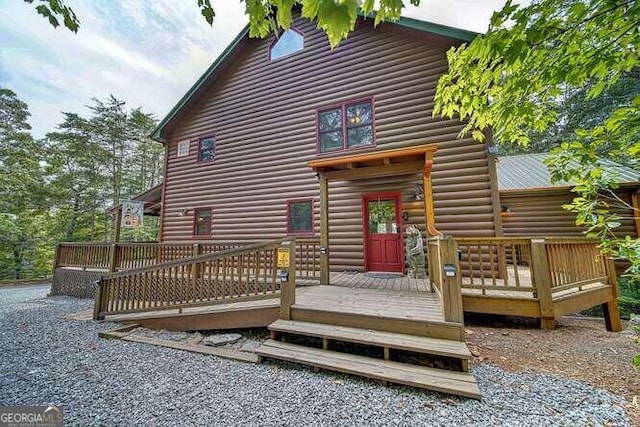 back of property featuring a wooden deck