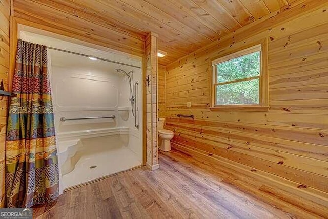 bathroom featuring hardwood / wood-style floors, wood walls, toilet, and wood ceiling