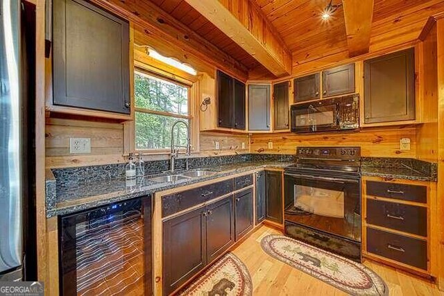 kitchen featuring sink, light hardwood / wood-style flooring, black appliances, and wood ceiling