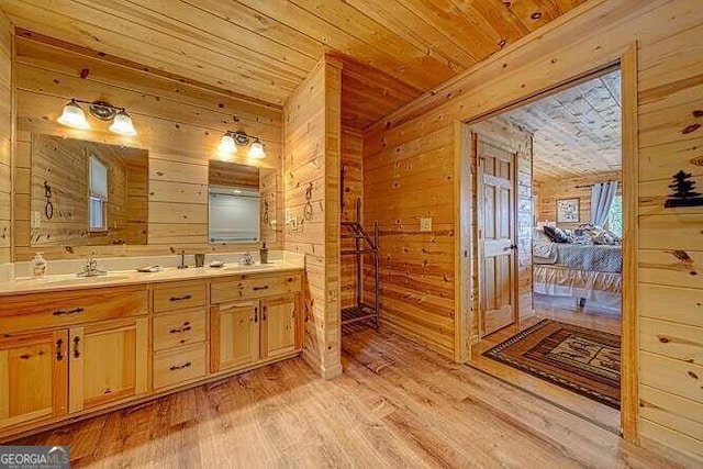 bathroom with wooden walls, wooden ceiling, hardwood / wood-style flooring, and dual bowl vanity