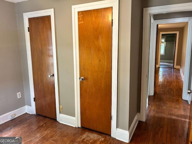 corridor featuring dark hardwood / wood-style floors