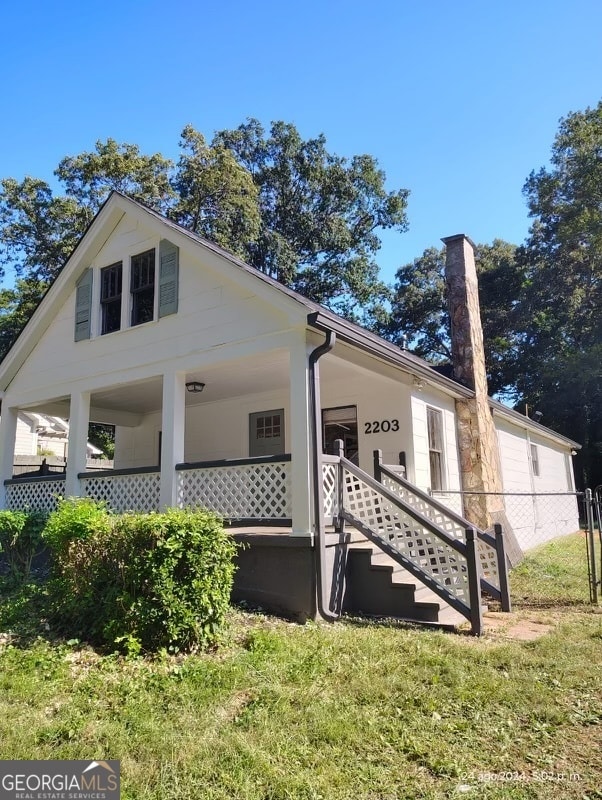 exterior space with a lawn and covered porch