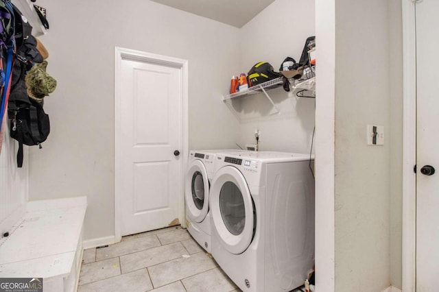 washroom featuring light tile patterned floors and washer and dryer