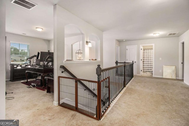 hallway featuring light colored carpet