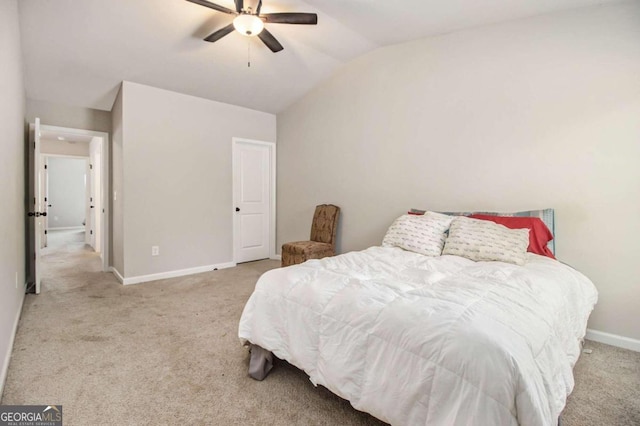 carpeted bedroom featuring lofted ceiling and ceiling fan