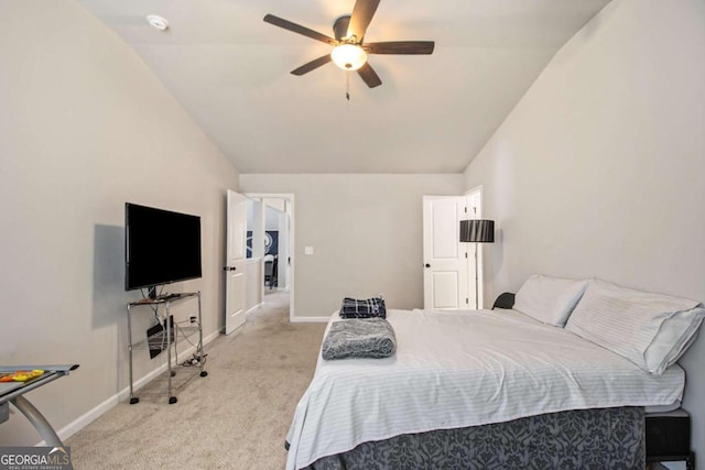 carpeted bedroom with ceiling fan and vaulted ceiling