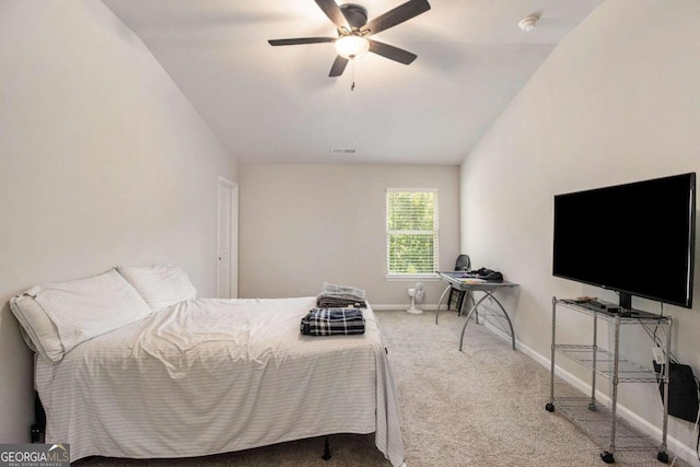 bedroom with vaulted ceiling, ceiling fan, and carpet flooring