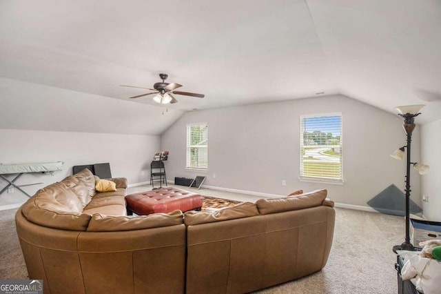 carpeted living room with ceiling fan and lofted ceiling